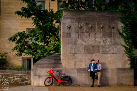 An epic Adams Morgan DC engagement picture as The couple takes a minute near a very iconic bridge, complete with the bike share bike