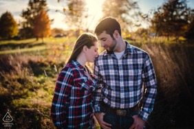 Lincoln, IL Artful Engagement Picture at a family farm as the couple is Resting into each other during the sunset