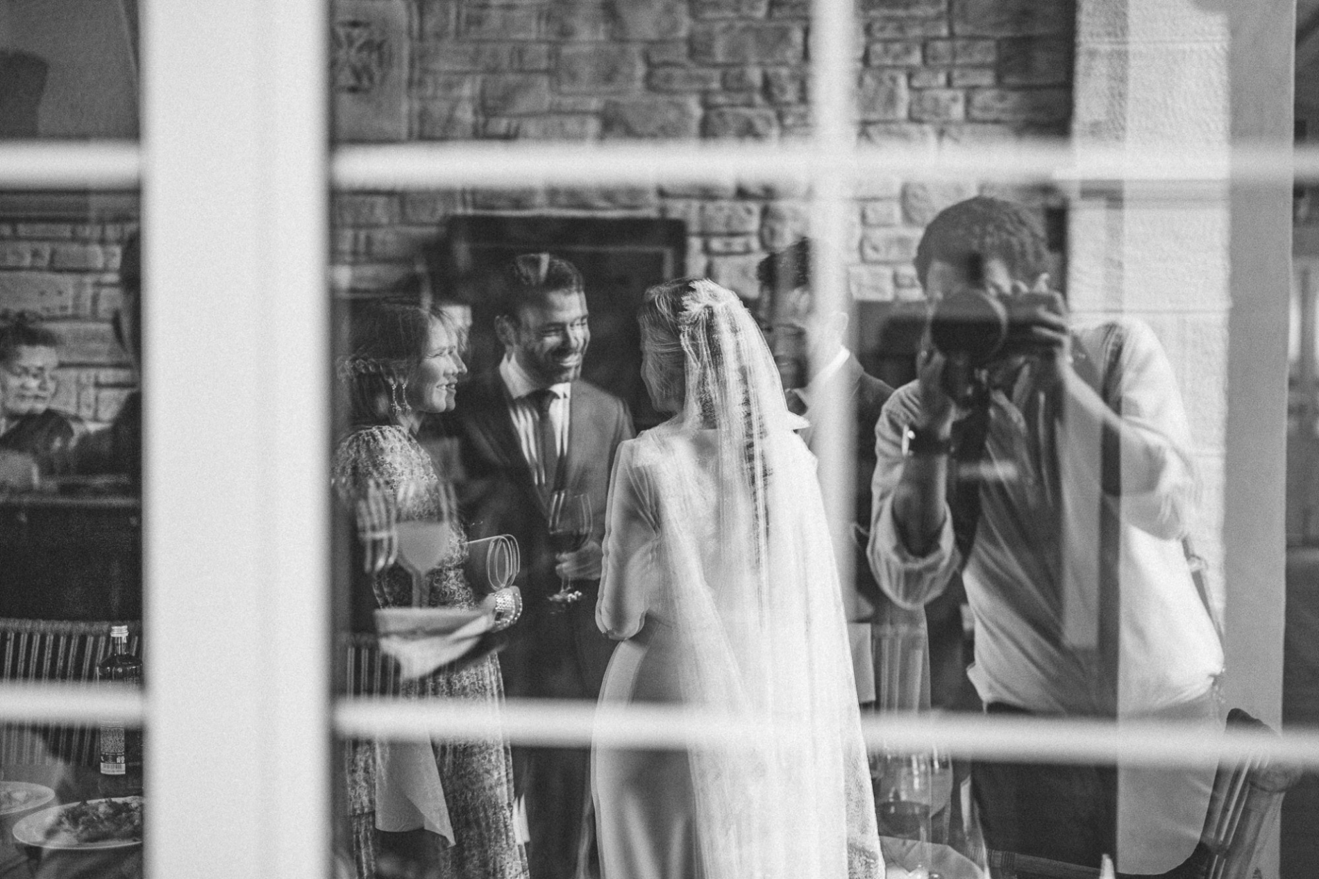 Washington DC wedding photographer working a shot of a couple through reflecting glass