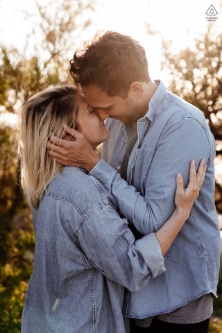 Herault pre wedding photo of a couple kissing in matching denim tops