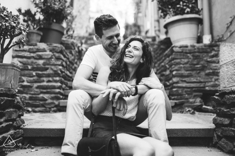 A Collioure couple laughing on stairs during an urban BW portrait session