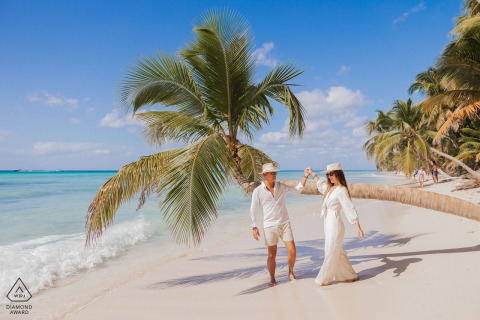 During their engagement portrait session, the couple having fun on the beach at Isla Saona, Dominican Republic.