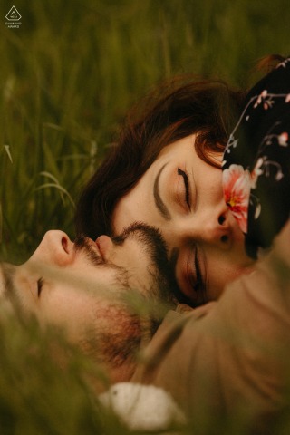 At Lac de la Gimone in France, the soon-to-be-wed couple shared a tender and warm embrace while lying in the grass together during their engagement portrait session.