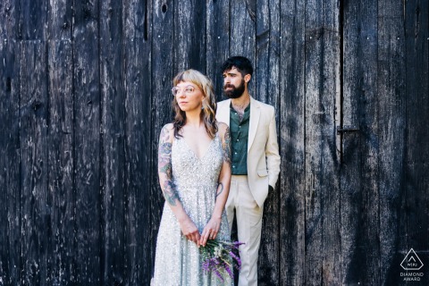 During their engagement portrait session at Basque Country France, the couple stood in front of a rustic wooden planked farmhouse door, creating a minimalistic and timeless frame for their upcoming wedding.
