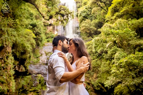 During their engagement portrait session at São Francisco de Paula - Rio Grande do Sul, the couple's passionate kissing and tender embrace captured against the backdrop of a beautiful waterfall promised a future filled with love.