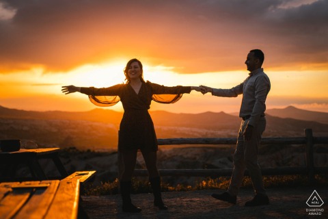 In Cappadocia, Turkey, the couple swayed in the sunlight, their outlines blending into partial silhouettes, capturing the essence of their upcoming nuptials.