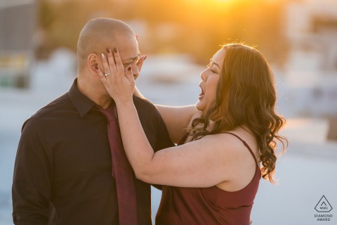 At Downtown Los Angeles, CA, the couple stand on the roof of their condo complex, illuminated by soft backlit, sunset lighting, capturing their love as they prepare to say "I do."