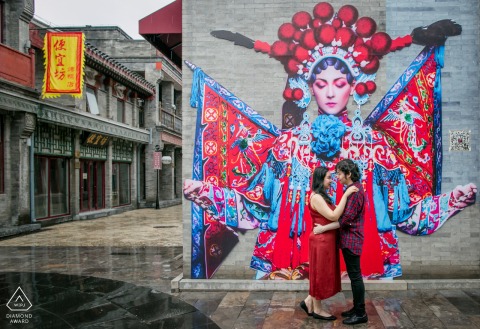 In Beijing Dashilan Pedestrian Street, the couple gazes into each other's eyes under the posters of Peking Opera characters, encapsulating their love in an urban setting before their upcoming wedding.