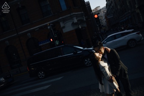 At the Bund in Shanghai, China, a couple getting married posed for pictures in the spotlight of an urban shaft of light during their engagement portrait session.