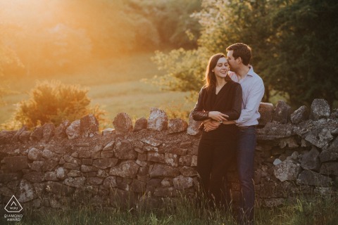 At Cheddar Gorge in Somerset, a couple hugs each other tightly as the sun sets behind them.