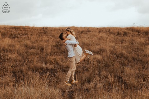 At Topo do Mundo in Brazil, the couple posed for their engagement photos, embracing each other with her lifting her feet up high in the air as he picks her up.