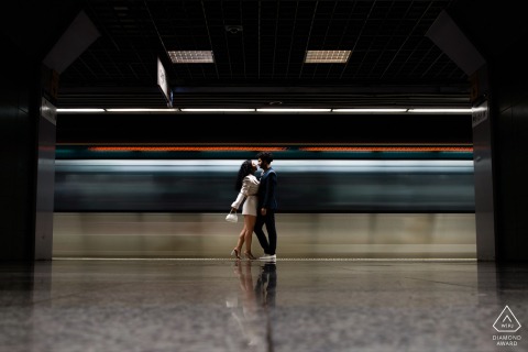 At Sirkeci, Istanbul, a photographer used a slow shutter speed to blur the passing train, creating a beautiful and symmetrical portrait of the couple in front of the metro.