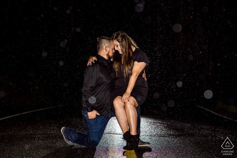 In Alice, CO, the couple posed in the rain at night at St. Mary's church: she sat down while he stood up, their heads close together in a loving pose.