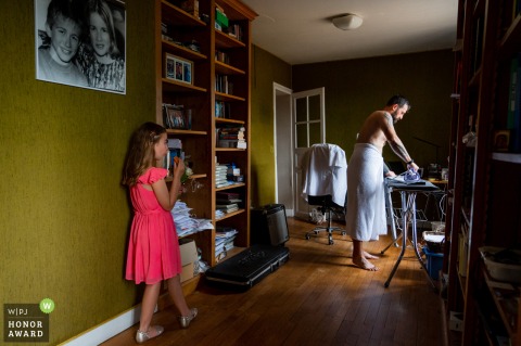 In Angers, at home, the groom is ironing his shirt before the wedding ceremony
