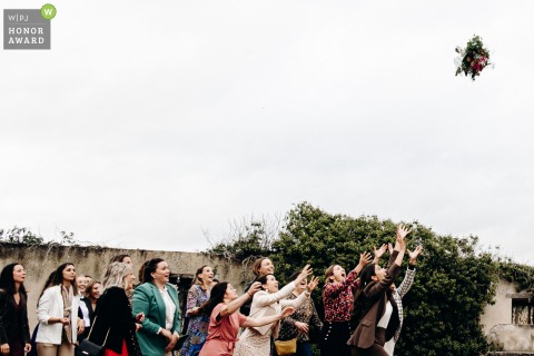 Outside of Domaine des Roches - Indre, the bride's bouquet toss, and the guests trying to catch it