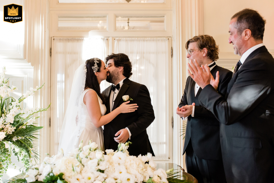 Professional wedding photographer capturing the bride and groom's kiss at the historic Pera Palace Hotel in Istanbul, Turkey. This stunning photo captures a memorable moment from the ceremony.